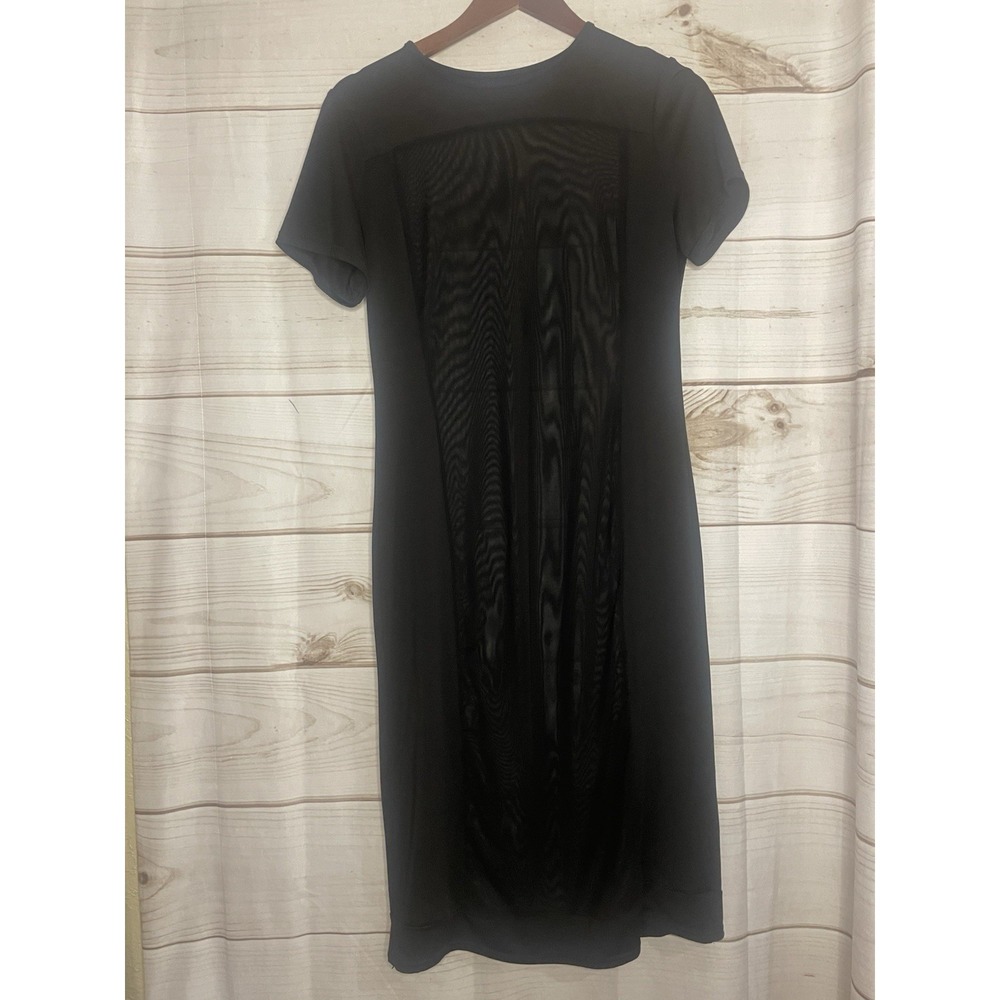 Black short-sleeve dress‎ featuring a central sheer mesh panel detai